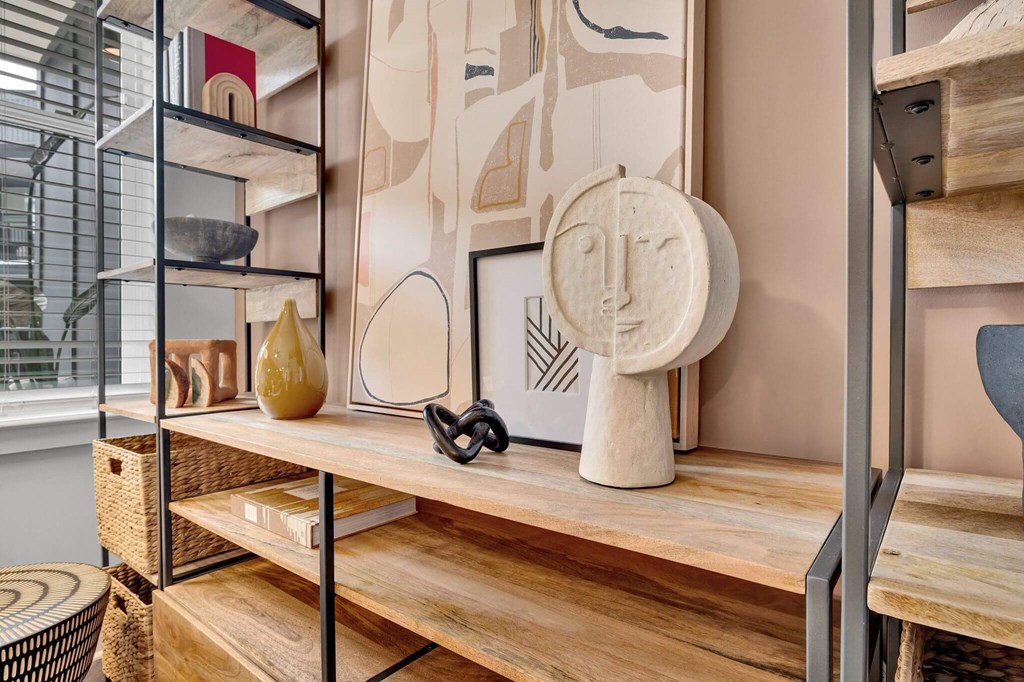 a living room with a wooden shelf and a table with a sculpture