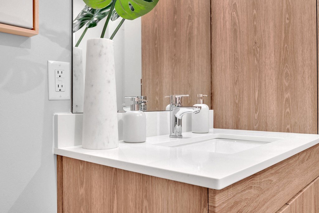 a bathroom with a white sink and a mirror