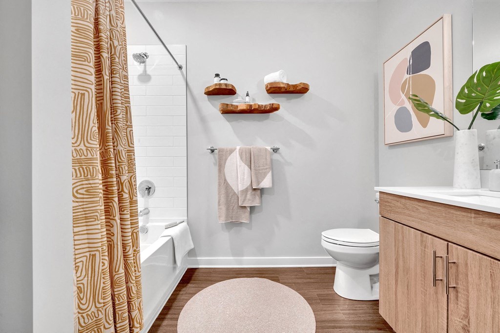 a bathroom with a shower curtain and a toilet and a sink