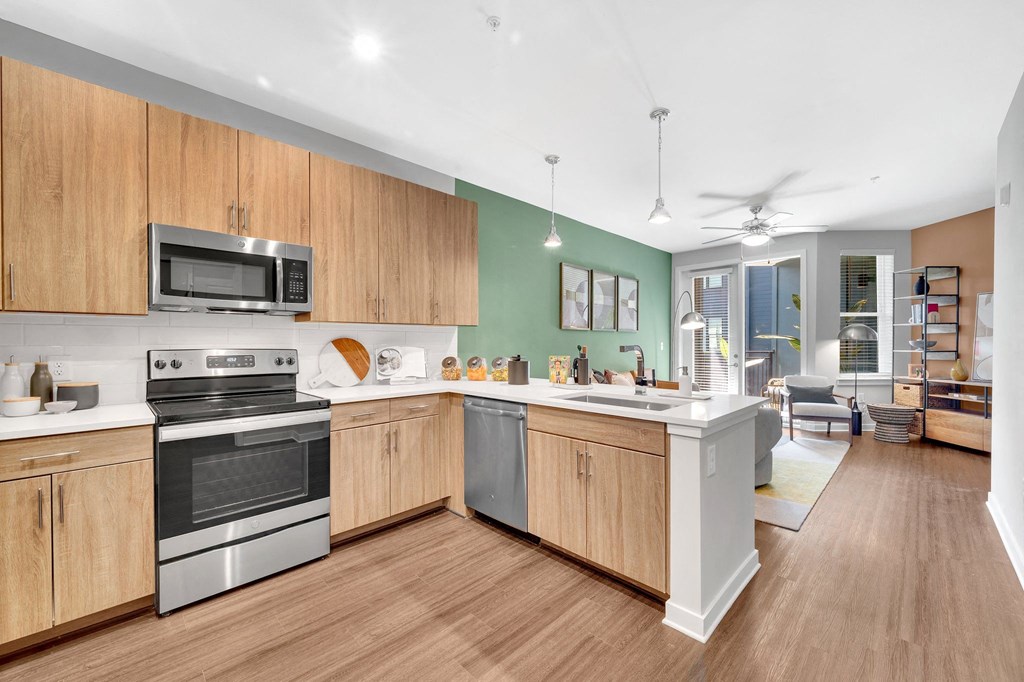 a large kitchen with wooden cabinets and stainless steel appliances