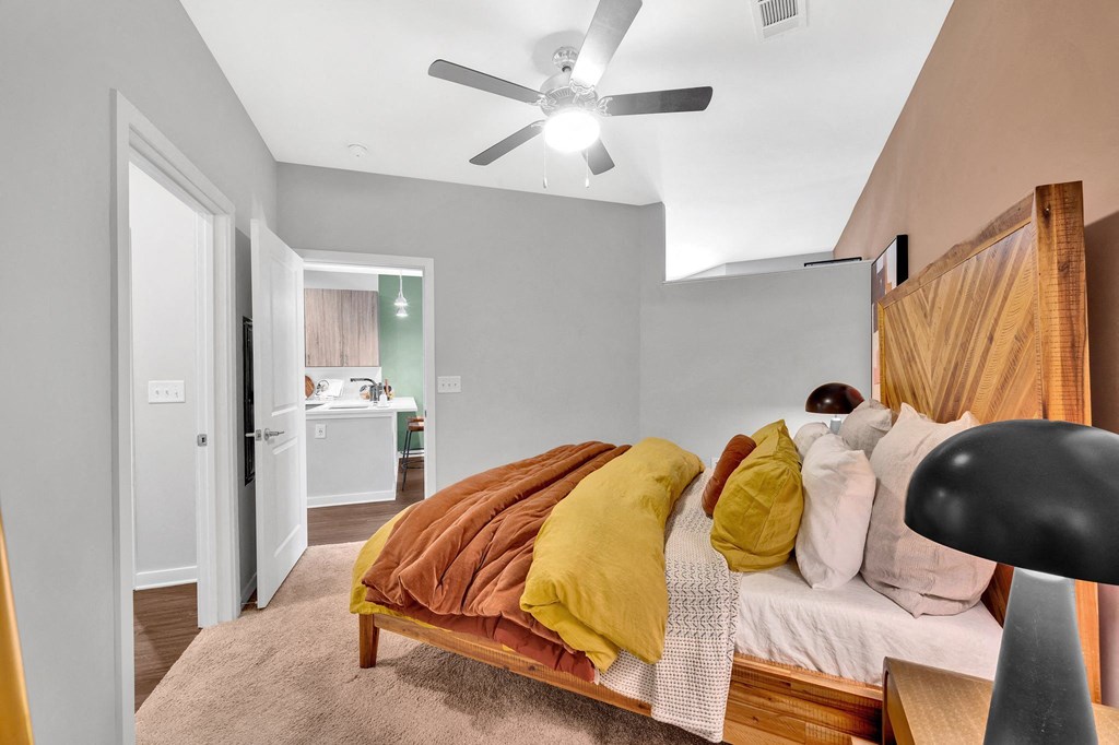 a bedroom with a bed and a ceiling fan