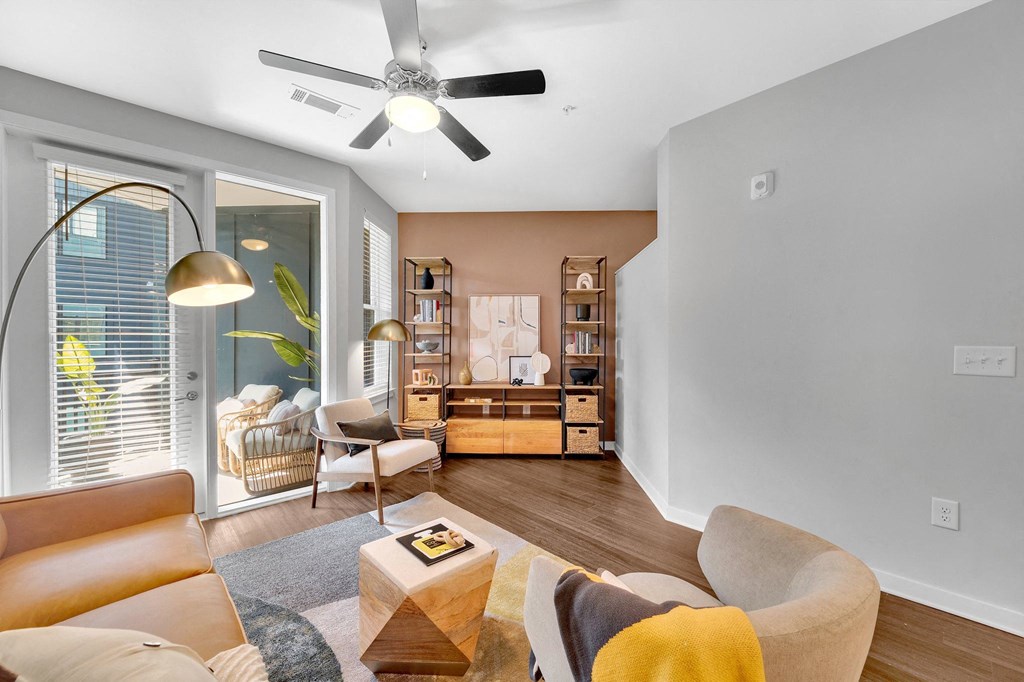 a living room with a couch and a ceiling fan