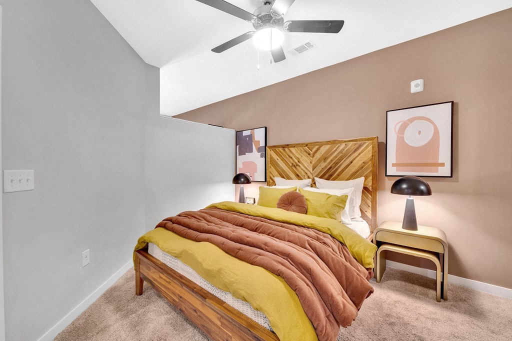 a bedroom with a bed and a ceiling fan