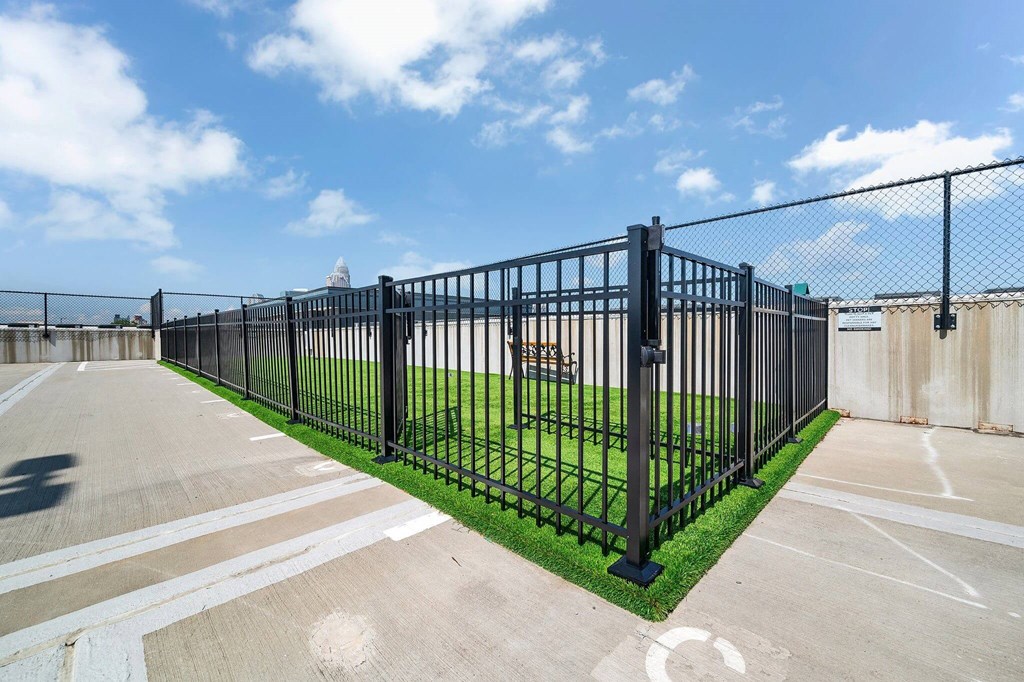 a fence with a field behind it in a parking lot