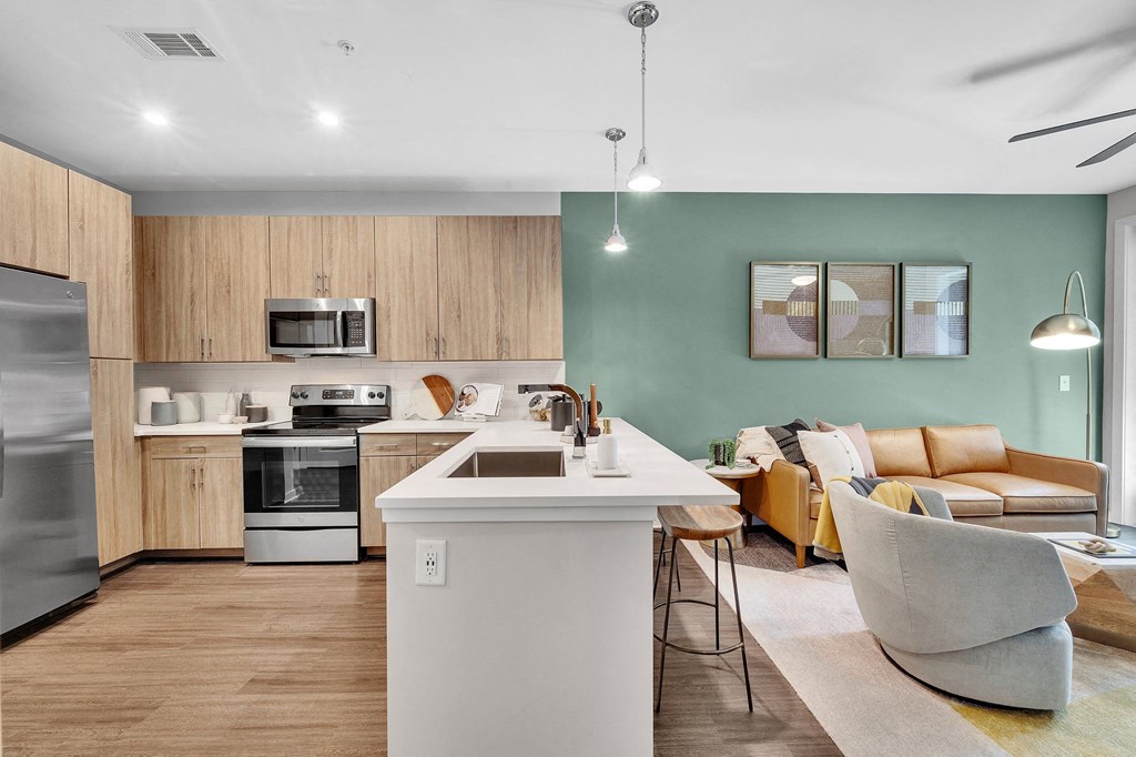 a living room with a kitchen and a dining room