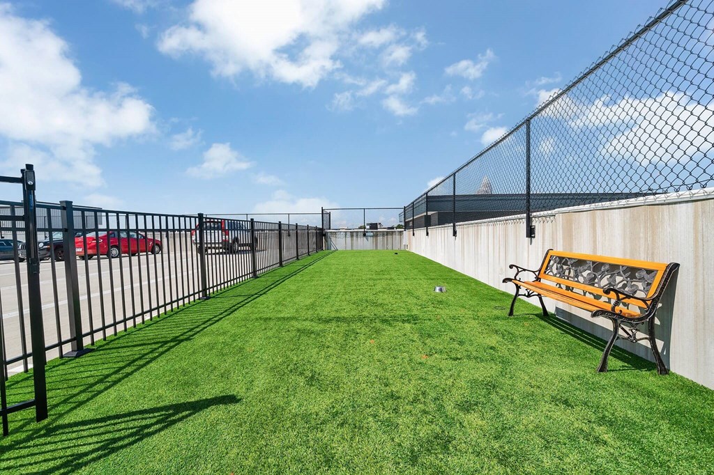 a fenced in yard with a bench and a chain link fence