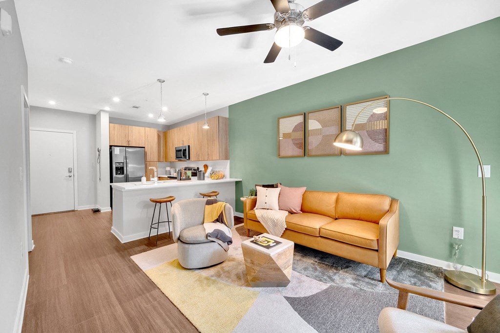 a living room with a couch and a kitchen in the background