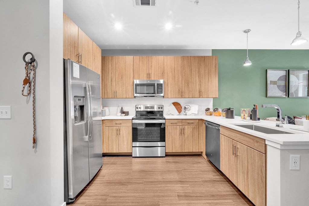 a kitchen with wooden cabinets and stainless steel appliances