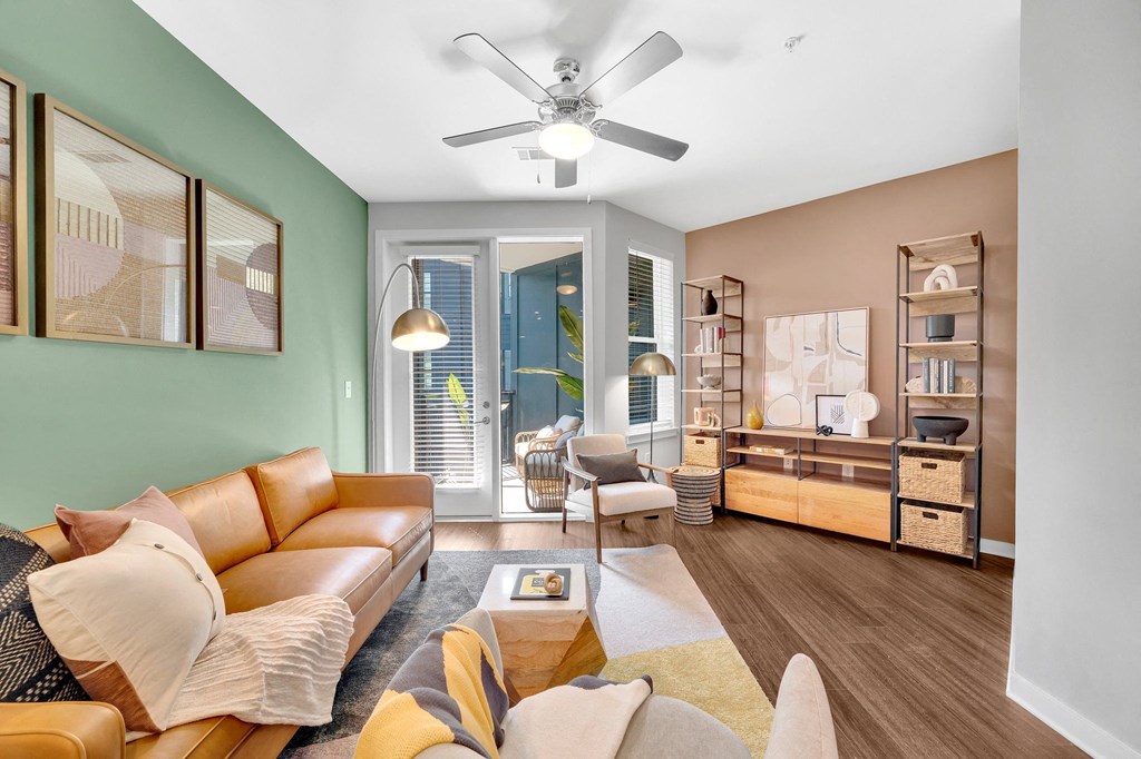 a living room with a couch and a ceiling fan