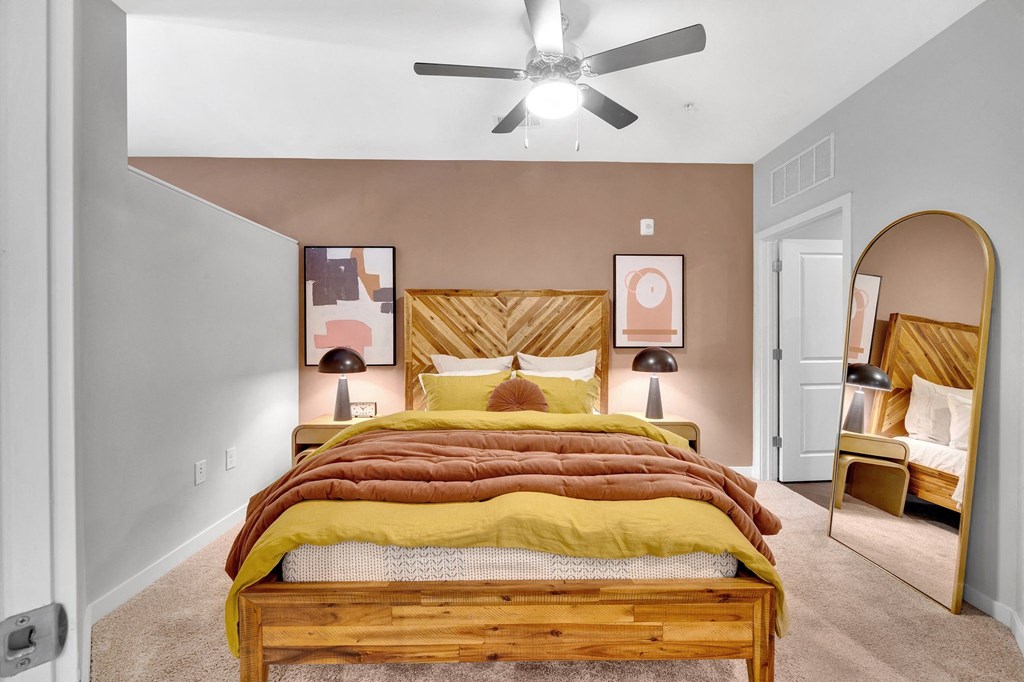 a bedroom with a bed and a ceiling fan
