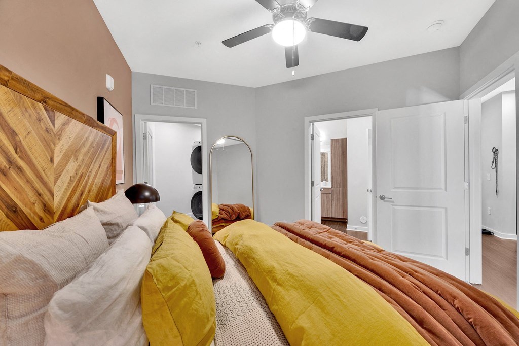 a bedroom with a bed and a ceiling fan