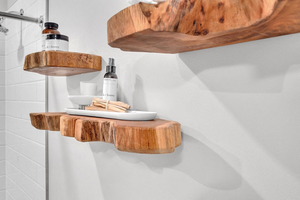 two wooden shelves on the wall in a bathroom