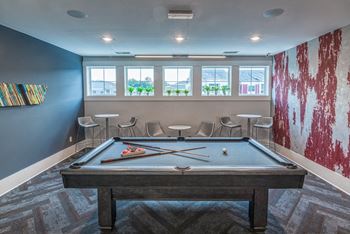 clubhouse with pool table and seating area with windows at the retreat