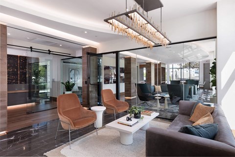 a living room with a couch and chairs and a coffee table