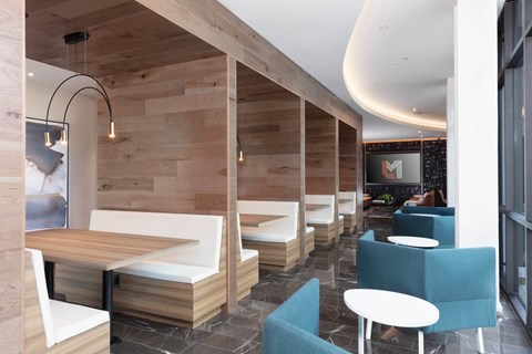 a restaurant with wooden walls and blue chairs and tables
