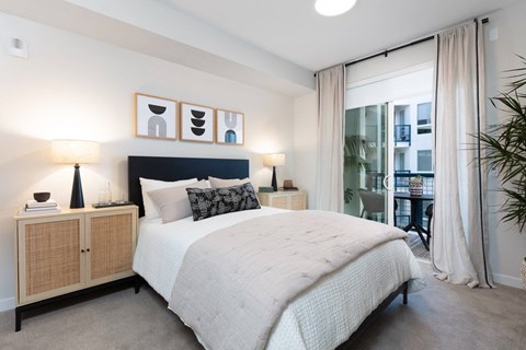 a bedroom with a bed and a large window