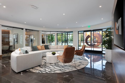 a living room with a white couch and chairs and a rug