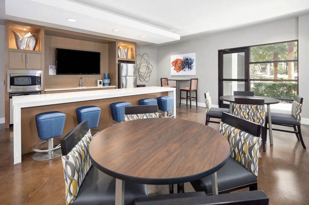 a dining room and kitchen with a table and chairs