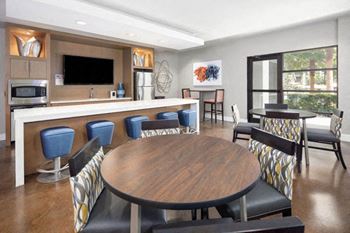 a dining room and kitchen with a table and chairs