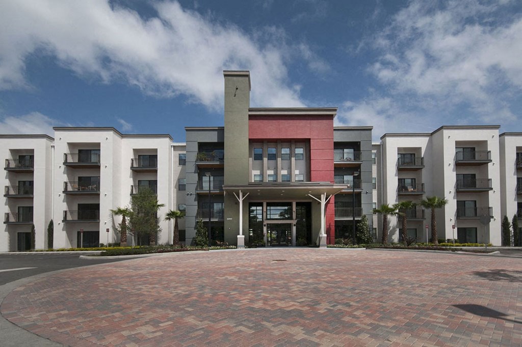 a large apartment building with a courtyard in front of it