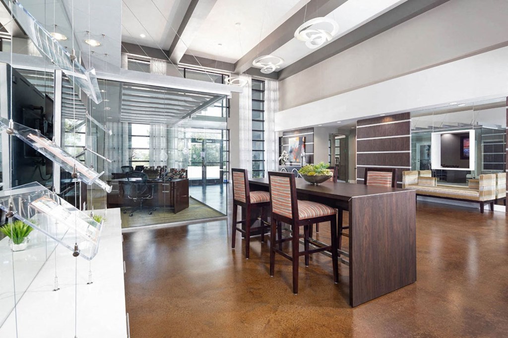 a dining room and living room with a table and chairs