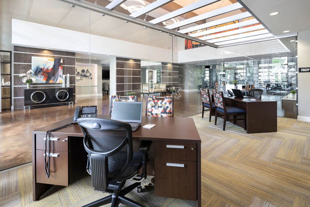 a large office with a desk and a laptop