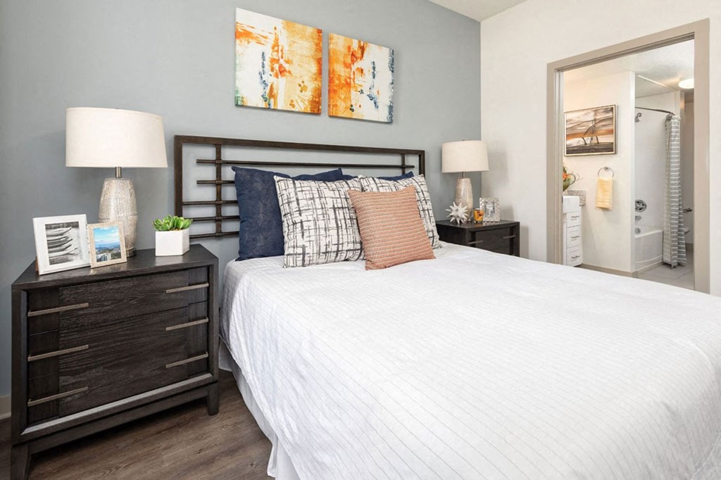 a bedroom with a bed and a mirror