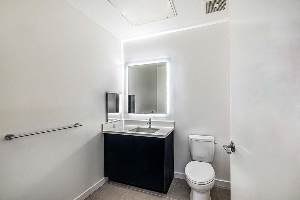 a bathroom with a toilet and a sink and a mirror