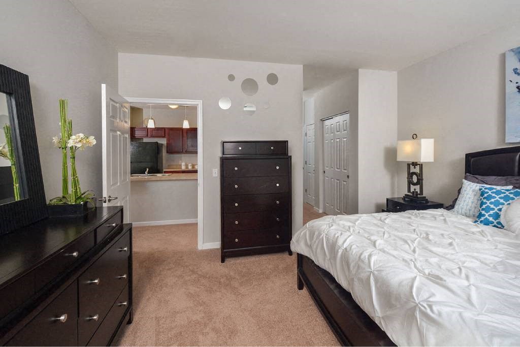 a bedroom with a bed and a dresser