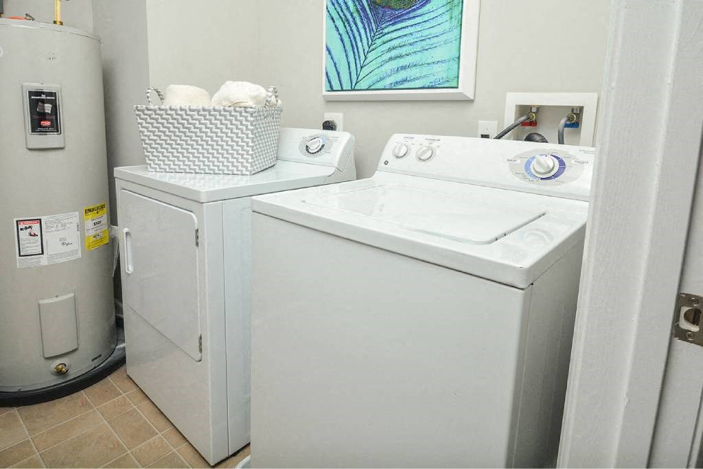 a white washer and dryer in a room with a refrigerator