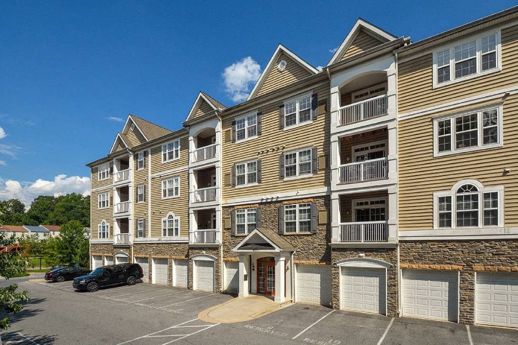 a large apartment building with a parking lot