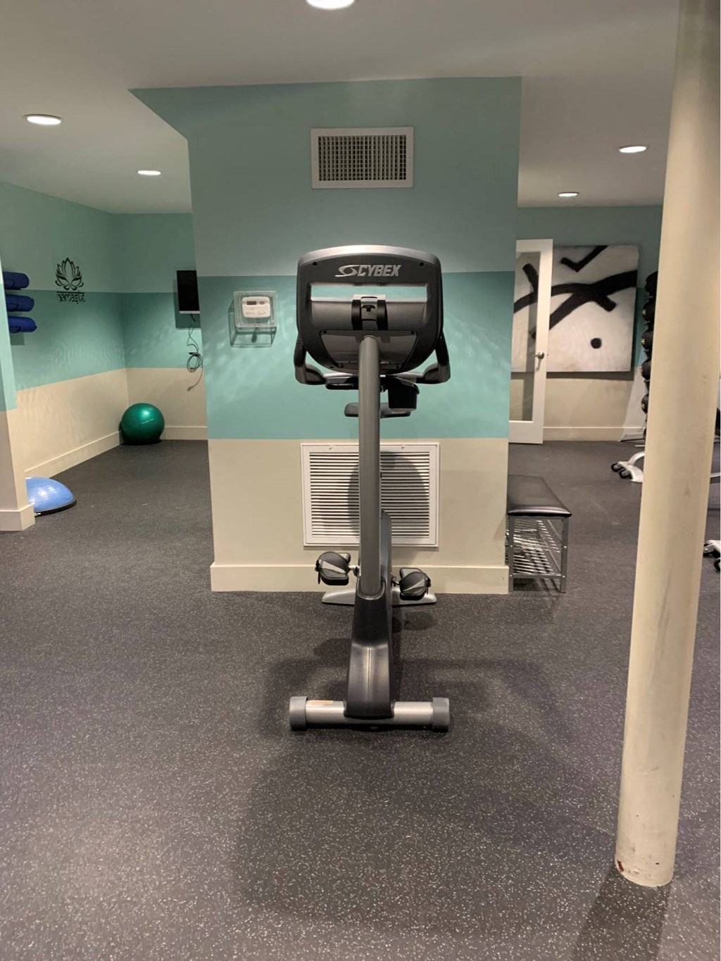 a workout room in a gym with a treadmill