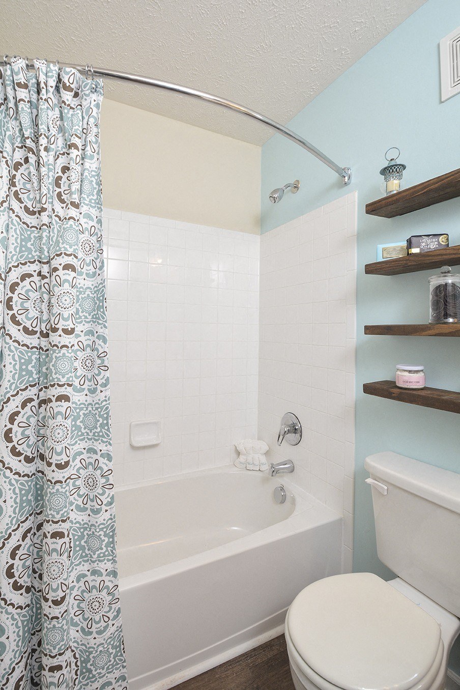 a blue and white bathroom with a shower curtain