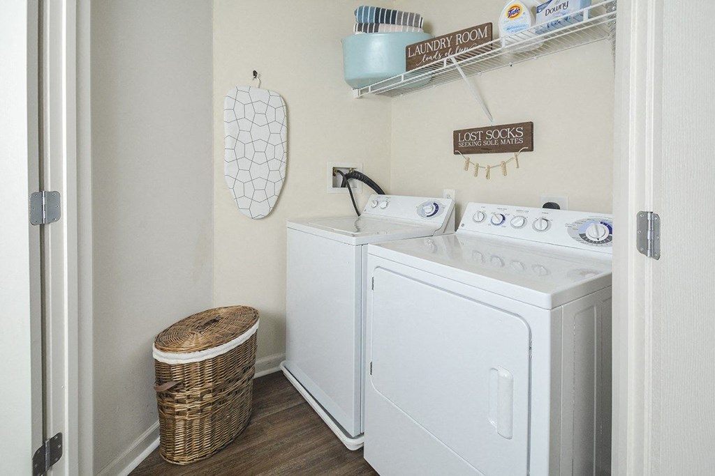a white washer and dryer in a laundry room with a basket