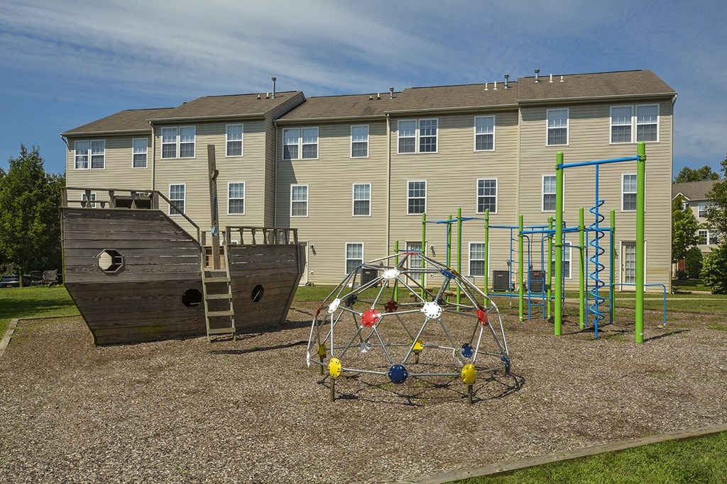 a playground in front of an apartment building