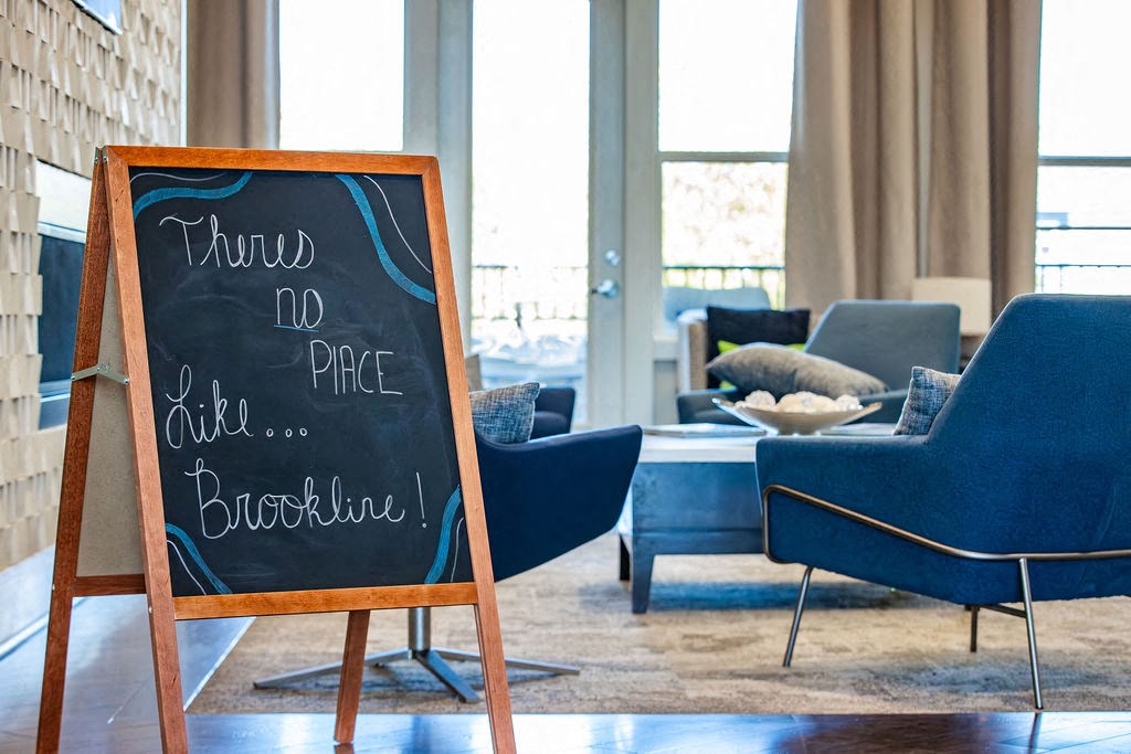 a chalkboard in a living room with a table and chairs