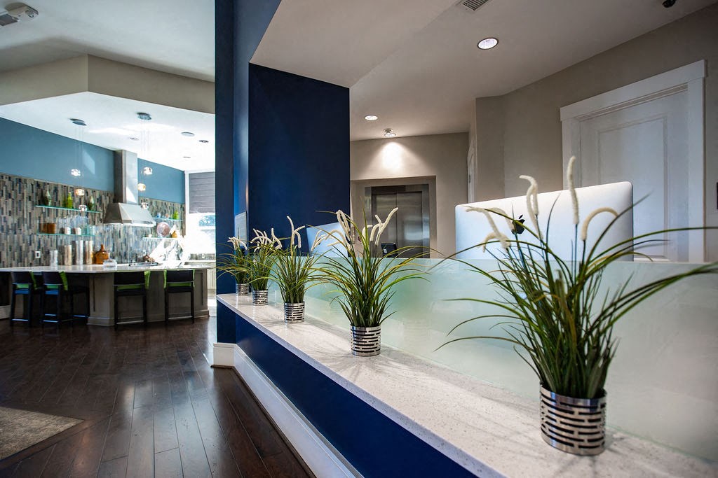 a blue and white lobby with plants on the counter