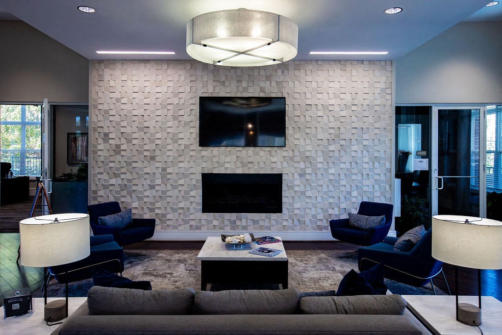 a stone wall in a living room with a couch and a television