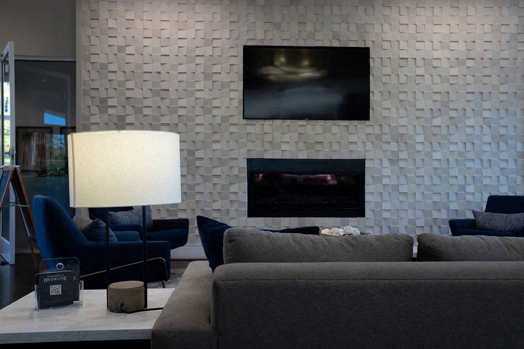 a living room with a couch and a table and a fireplace