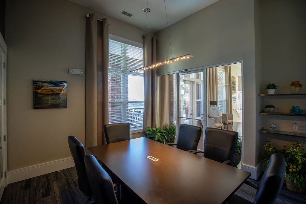 a conference room with a wooden table and chairs