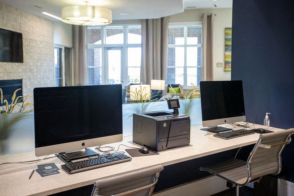 a desk with two monitors and a computer on it