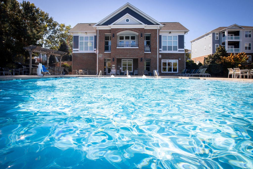 a large swimming pool in front of a house