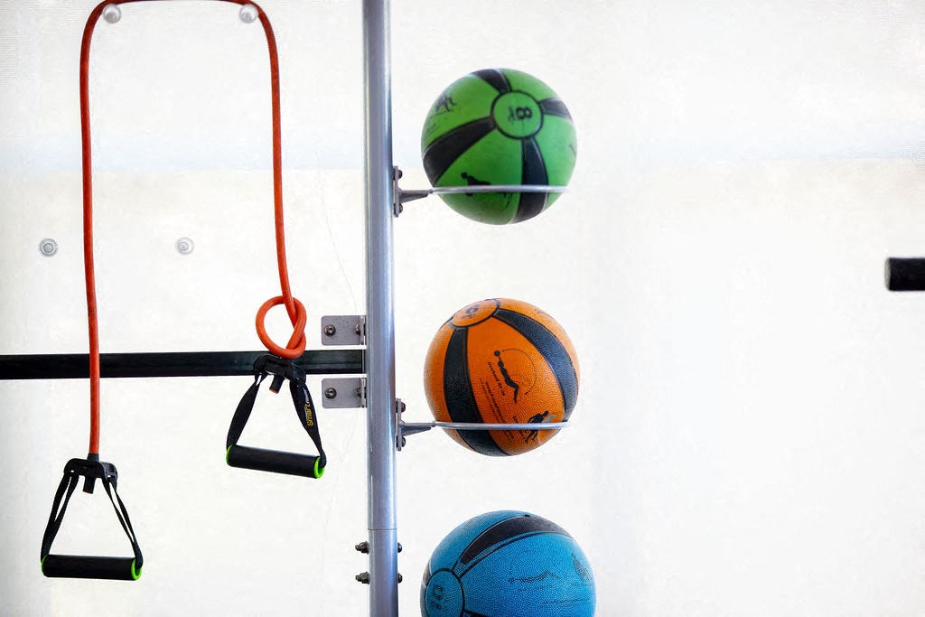 three basketballs on the hoop at a court