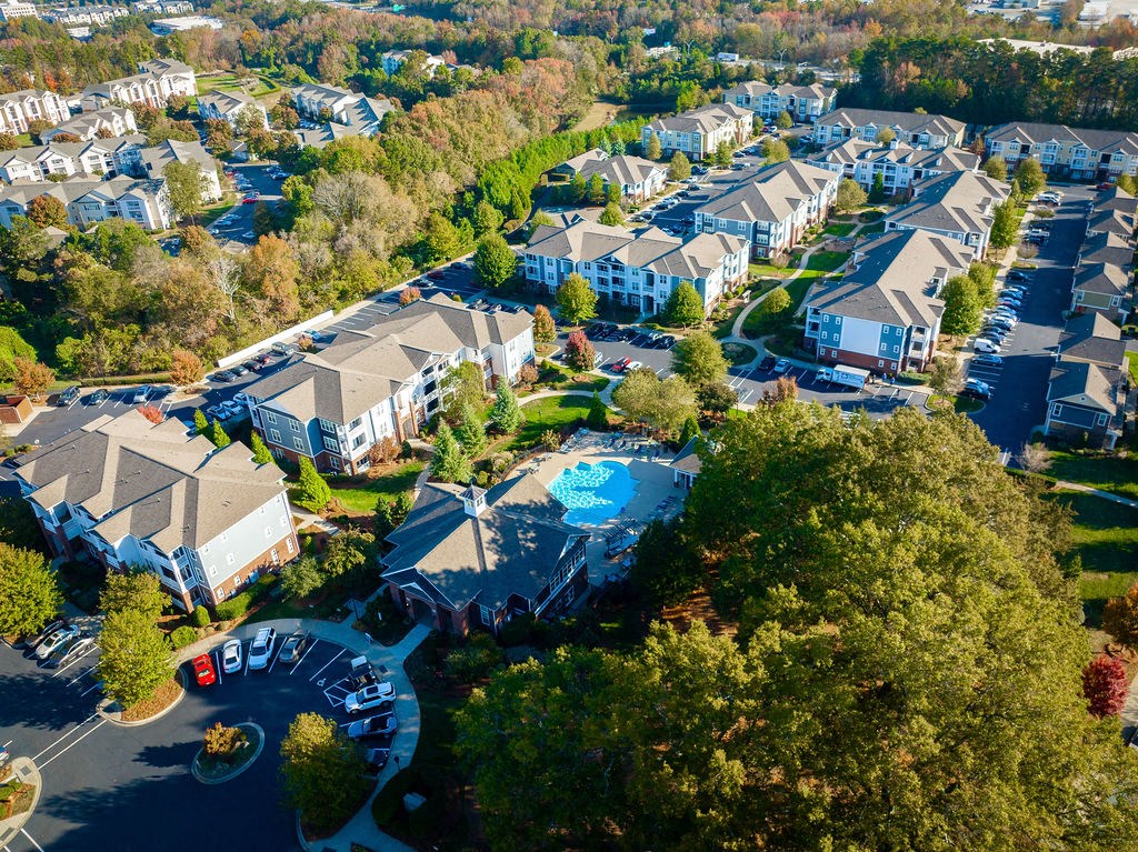 a aerial view of a neighborhood with houses and a swimming pool