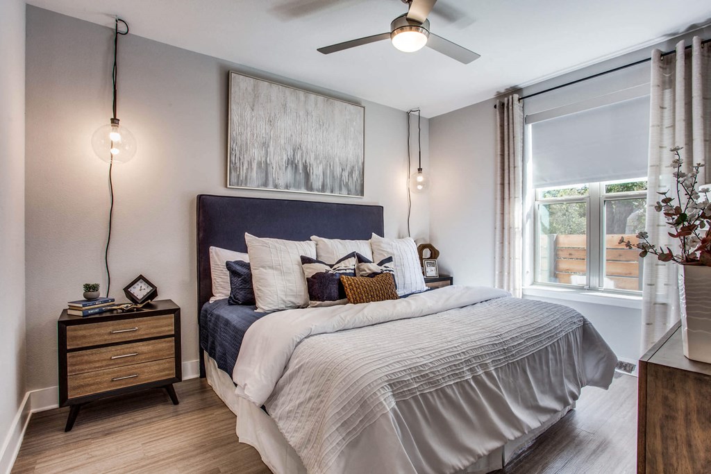a bedroom with a bed and a ceiling fan