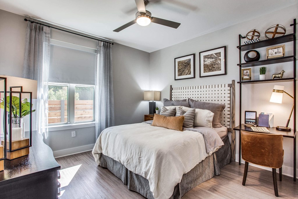 a bedroom with a bed and a ceiling fan