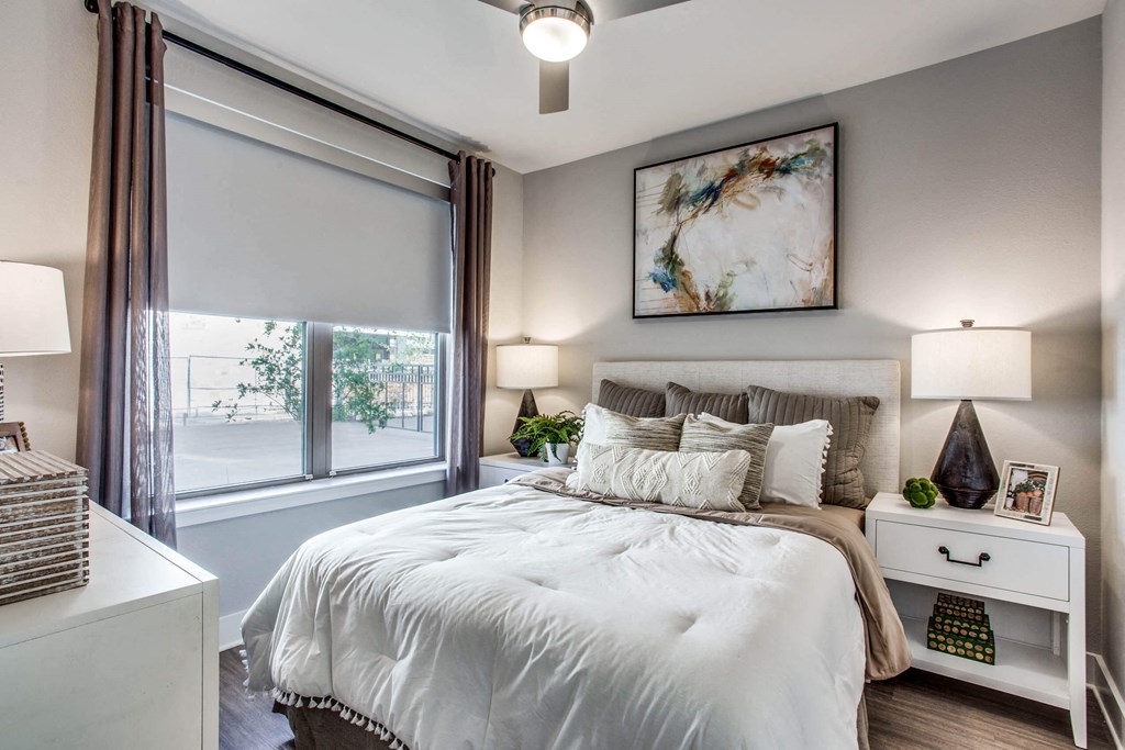 a bedroom with a large bed and a window