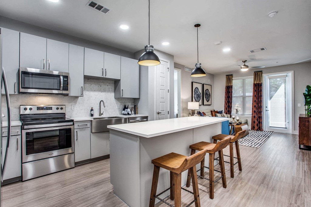 a kitchen with an island and stools