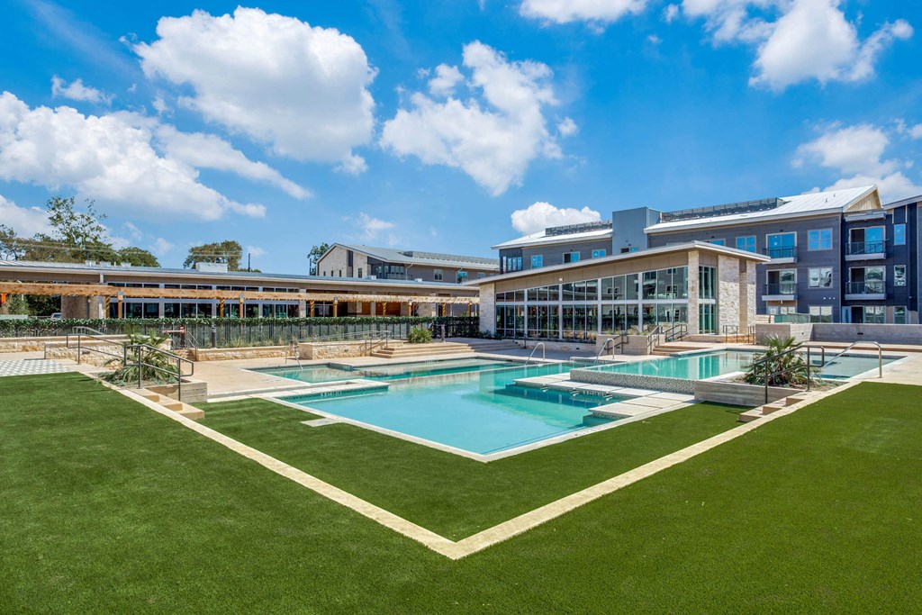 a large pool with a building in the background