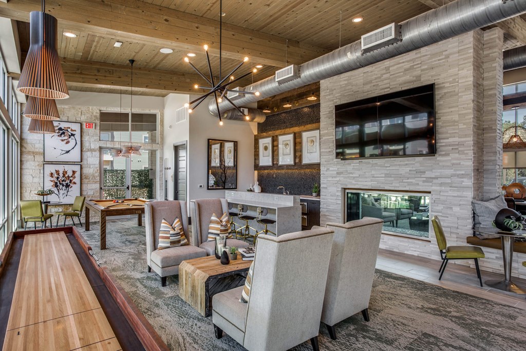 a large living room with a fireplace and chairs